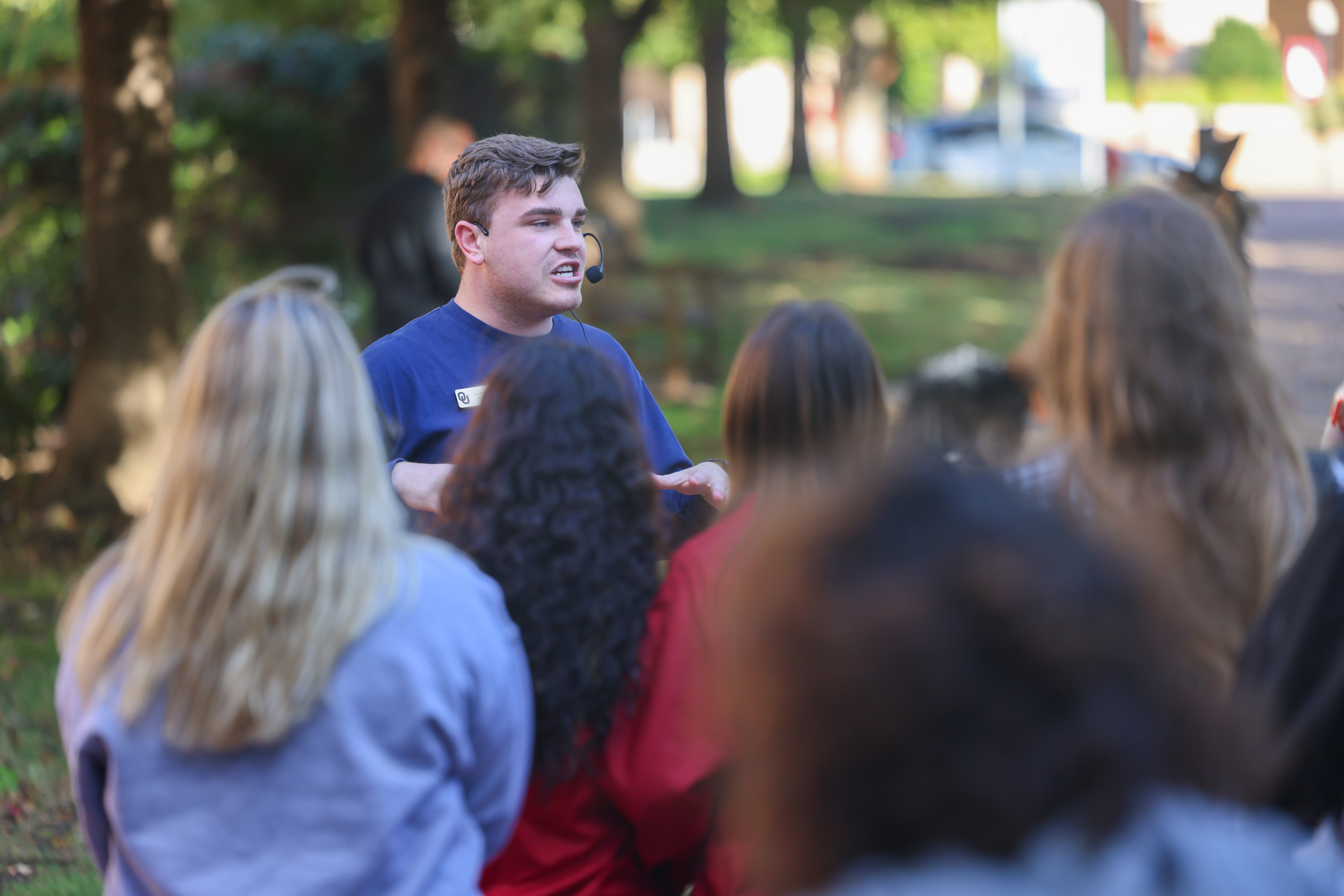 A Crimson Club student wears a microphone headset while giving a campus tour to prospective students.