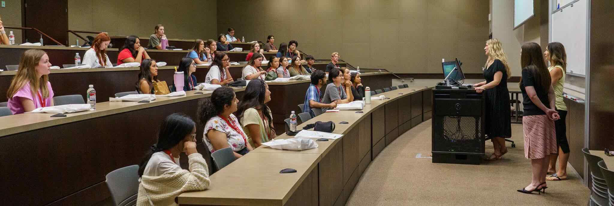 College of Allied Health Students sitting in an auditorium facing presenters during orientation.