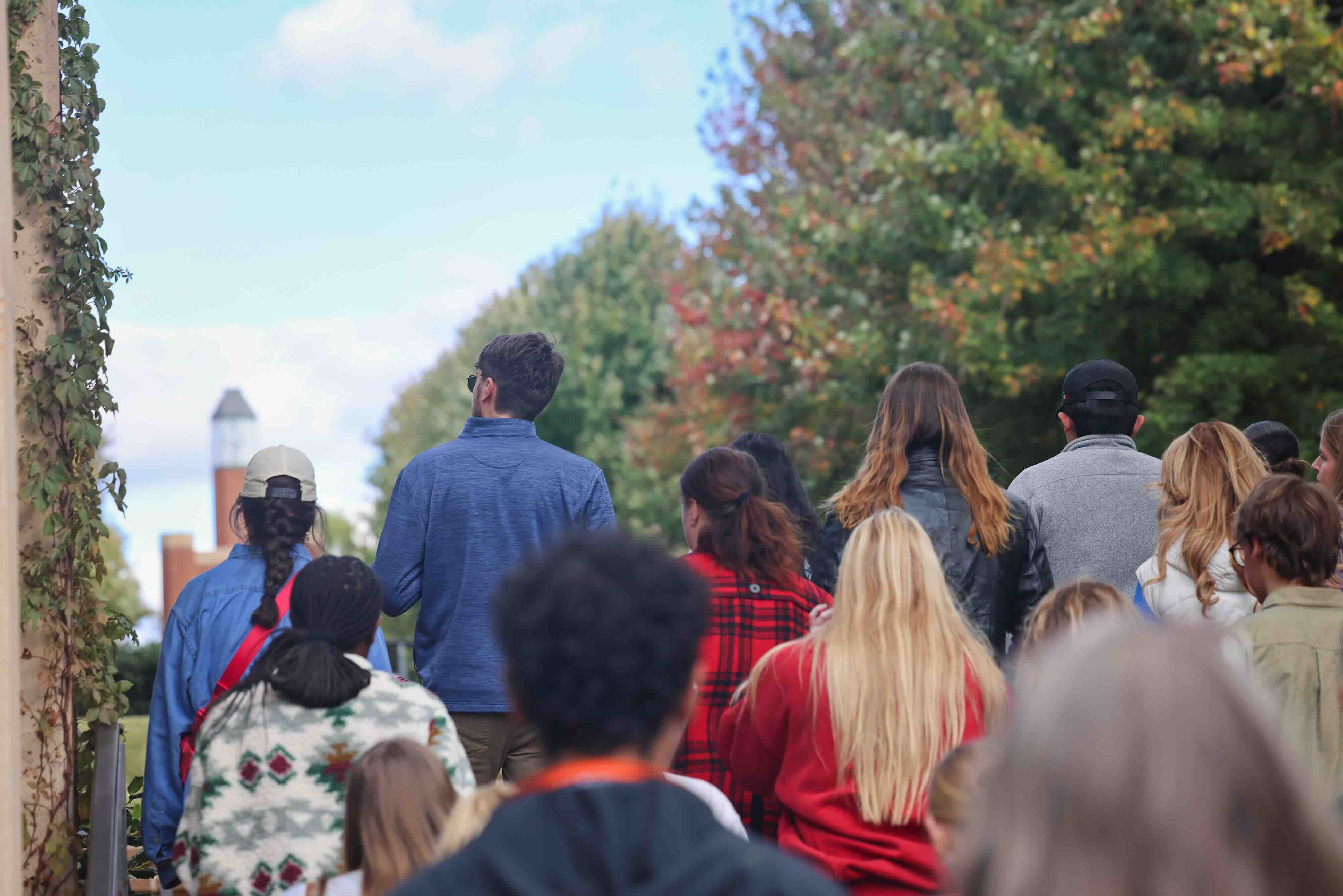A large group of students walking along the Stanton L. Young Walk during a campus tour.