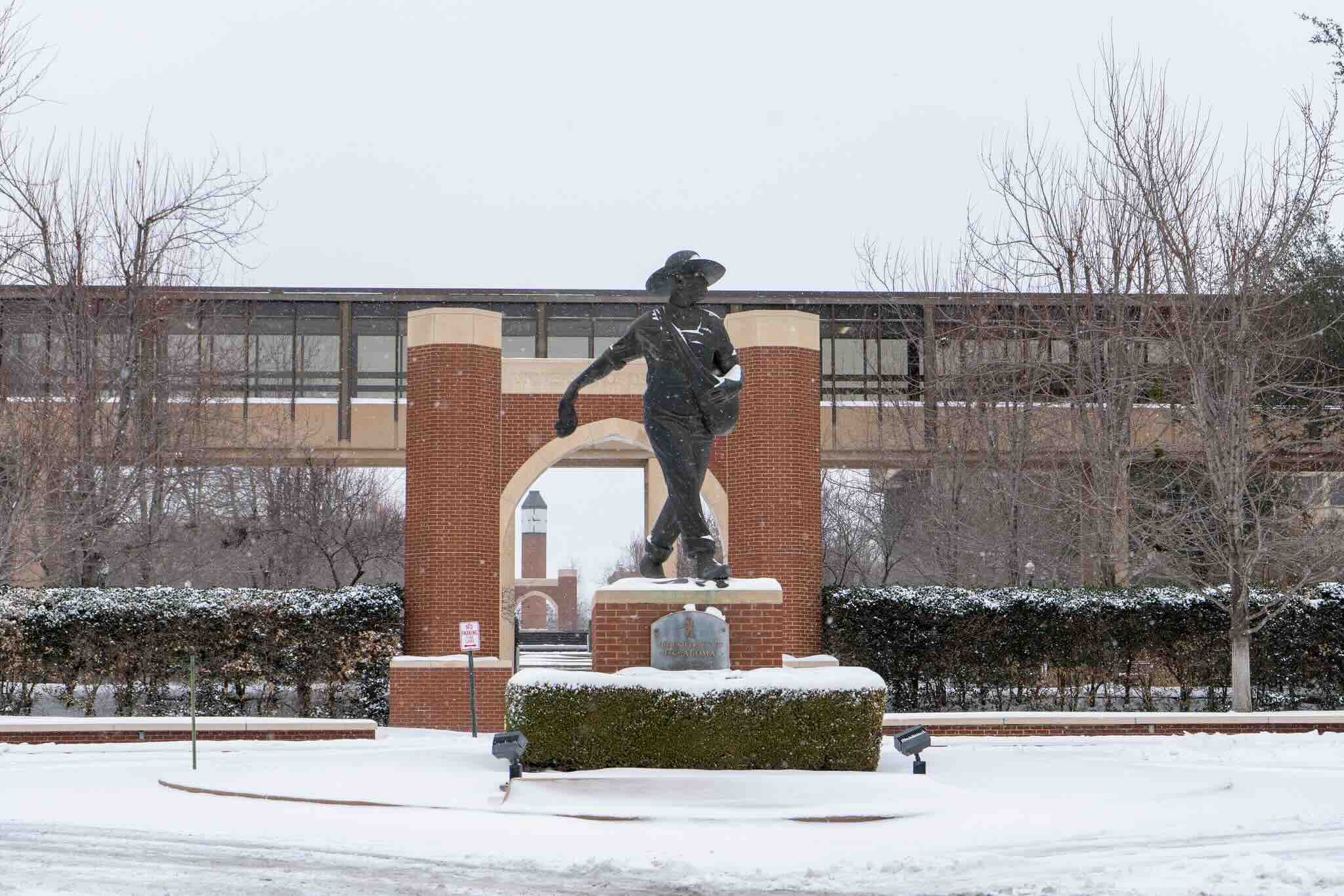 Wide shot of the Oklahoma City Sower statue on a snowy winter day.